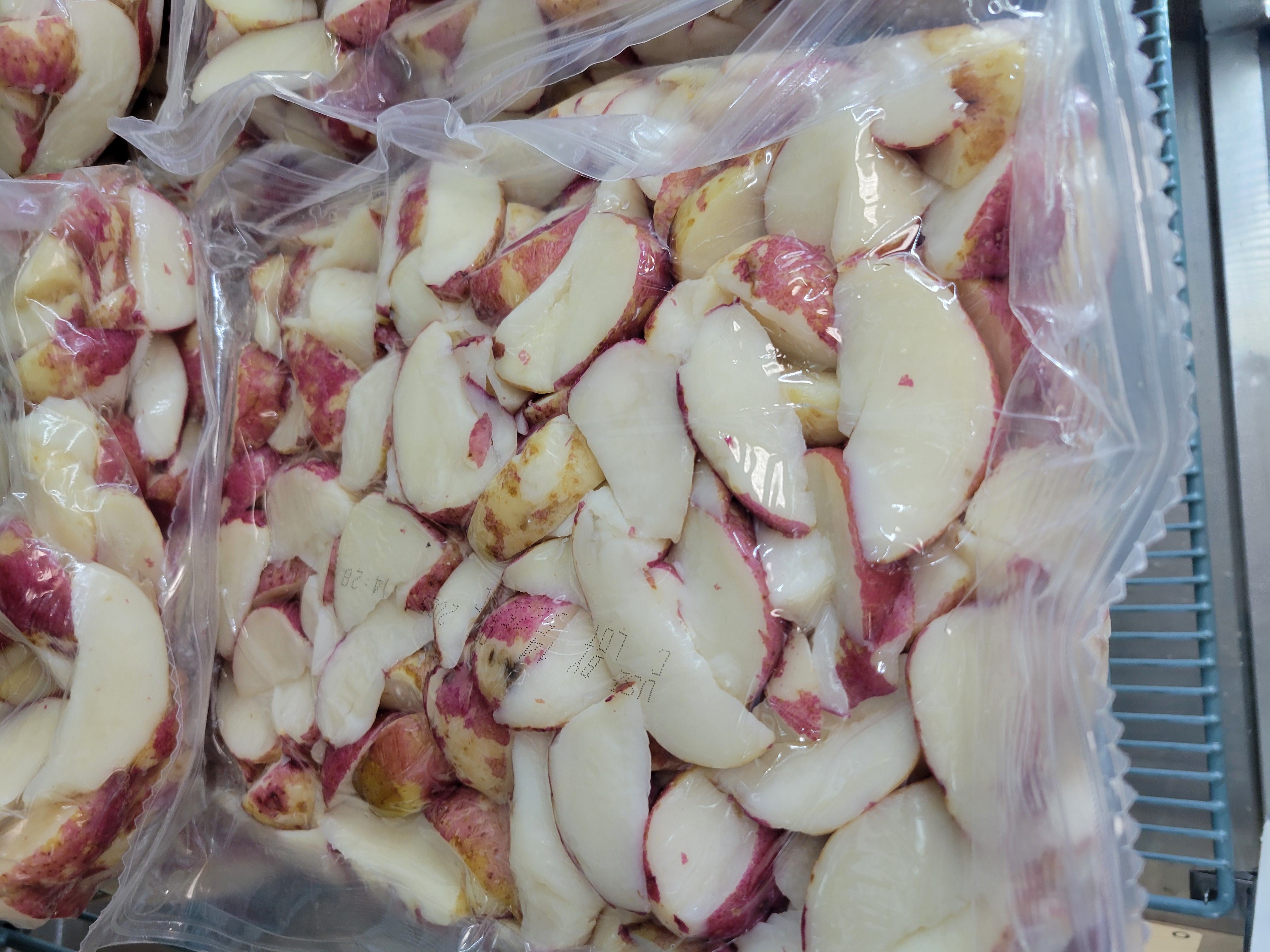 Sliced red potatoes packaged in a clear bag